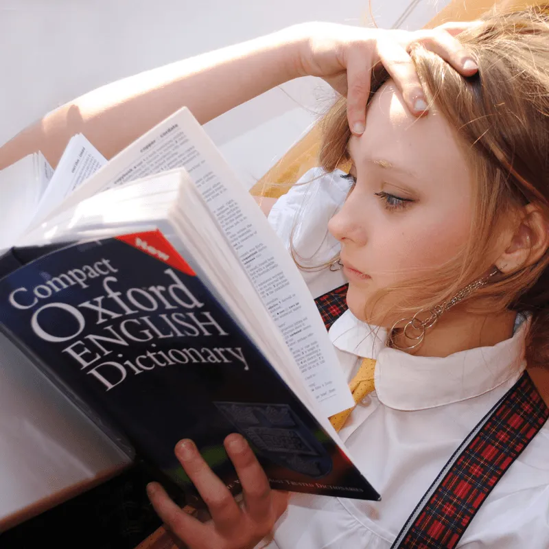 Sophie helping a child practice English